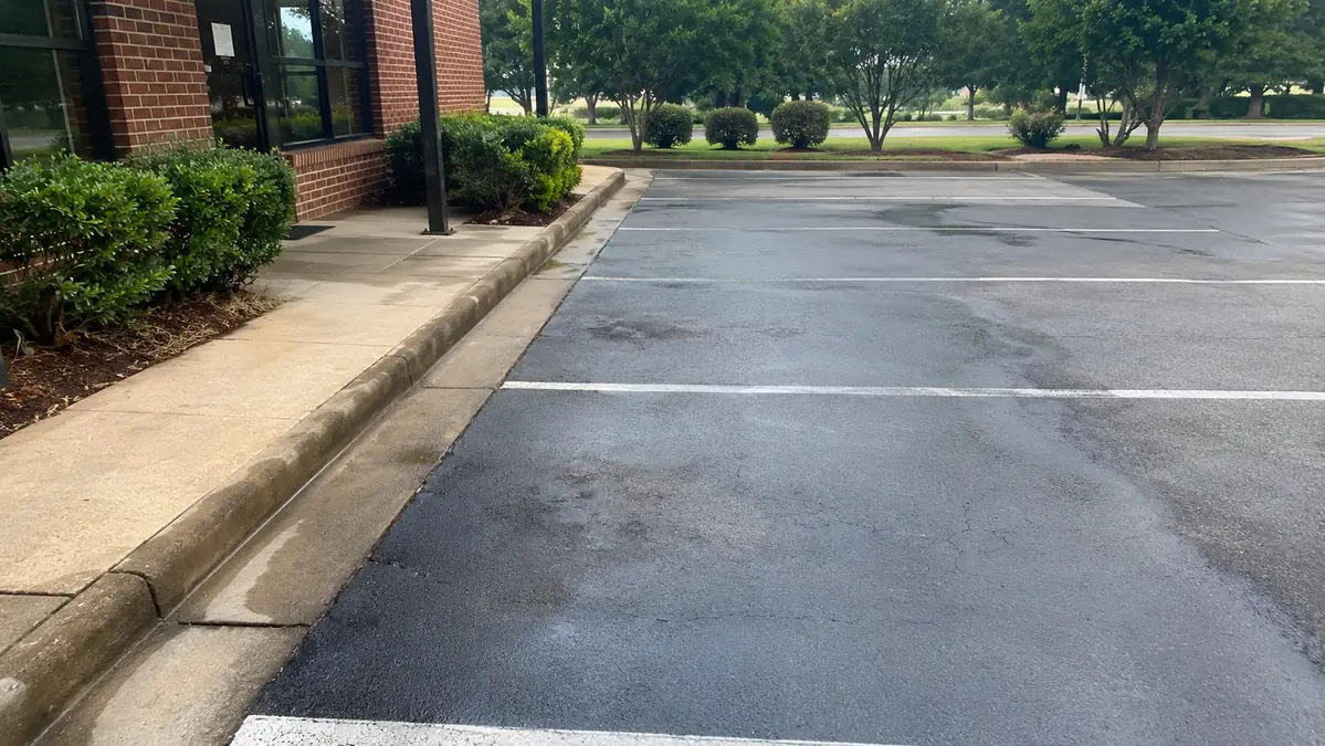 Clean parking area, sidewalk and curb at a municipal property in South Georgia